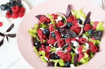 homemade berry vinaigrette. Salad with berries with vinaigrette. Vegetarian salad with raspberries and blueberries.