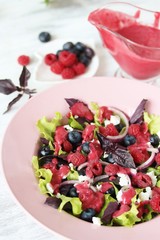 homemade berry vinaigrette. Salad with berries with vinaigrette. Vegetarian salad with raspberries and blueberries.