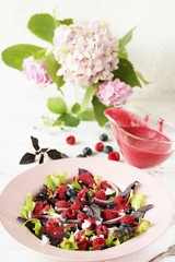homemade berry vinaigrette. Salad with berries with vinaigrette. Vegetarian salad with raspberries and blueberries.