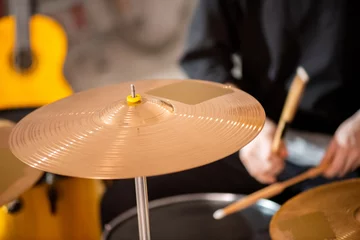 Fotobehang Round golden color cymbal as part of drum set on background of drummer © pressmaster