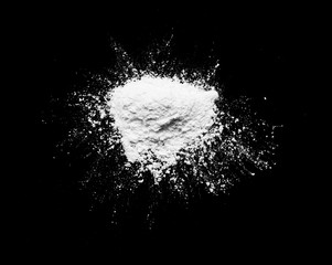 White powder isolated on the black background.