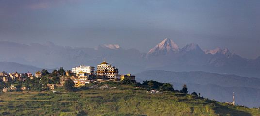 Buddhist monastery view in Nepal with Everest mountain range in the background during sunset