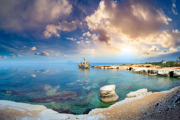 Cyprus beach. Paphos. Panorama of beach with remains of a ship. View of Mediterranean Sea. Landscape of the Cyprus coast. Nature of city of Paphos. Tour to city of Paphos. Cyprus attractions.