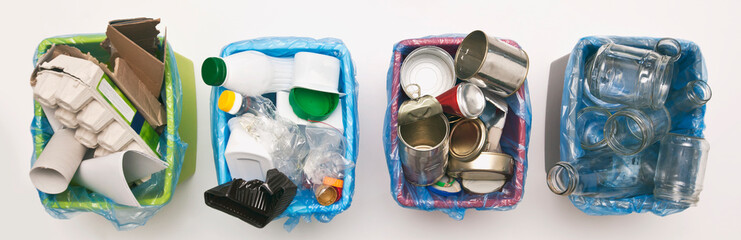 The four different container for sorting garbage. For plastic, paper, metal and glass