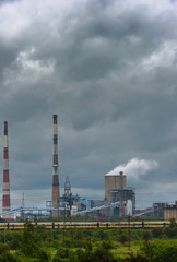 Fototapeta na wymiar View of Cooling Tower and Chimneys with Moody Sky.
