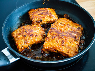 Frying pork ribs in cooking pan