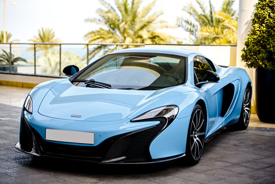 DUBAI, UAE - JANUARY 18, 2017: Blue luxury supercar McLaren on the road in Dubai