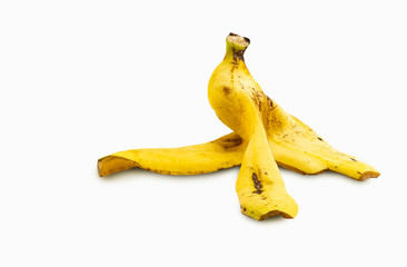 Close up big banana peel on ground, isolated banana peel on white background, low angle view close to the floor, some part raise. Clipping path in the file.