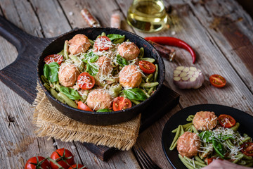 Delicious fresh pasta with meatballs, sauce, cherry tomatoes and basil