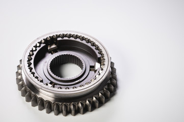 New parts on a gray background. Gears of gear shifting torque transmission. Conceptually mechanical background. Shiny gear box gear teeth