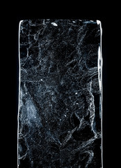 Large rectangle of clear ice with bubbles, against dark background. Block of clear pure frozen ice...