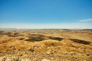 Makhtesh Ramon - Ramon Crater in Israel's Negev Desert from the Mitzpe Ramon lookout, with Mount Ramon in the background.