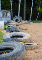 Old worn-out car tires are stacked in a pile .