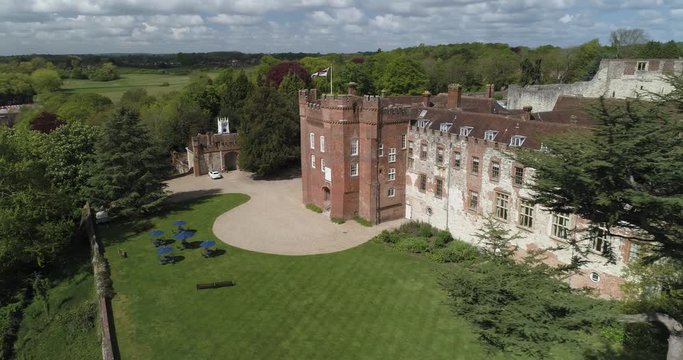 English wedding venue revealed from behind tall trees