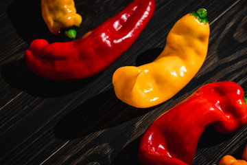 red and yellow peppers on wooden table