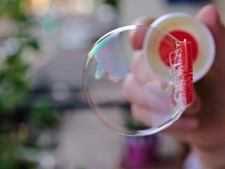 Close view of soap bubble blowing from the wand