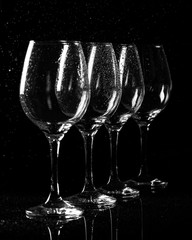 Wine glass on black with water drops