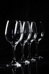 Wine glass on black with water drops