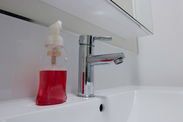 Liquid Hand soap used for cleaning hands next to a basin