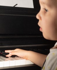 young child learning to play the piano