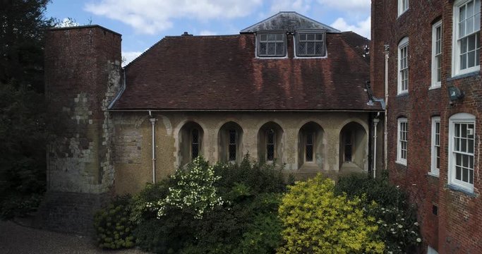 Beautiful outbuilding of a castle with colourful flowers