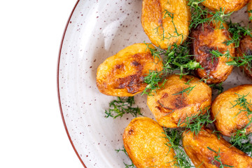 Fried fresh potatos and dill on a plate isolated on a white background. Top view