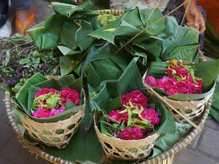 basket with flowers. Roses to be sown in the tomb. Roses wrapped in banana leaves are sold at local markets in Indonesia