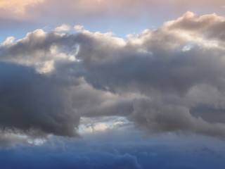 Dark and white clouds on a background of blue sky