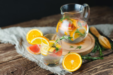 Homemade lemonade with lemon, orange and grapefruit on a wooden table