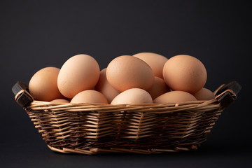 eggs in basket on black background