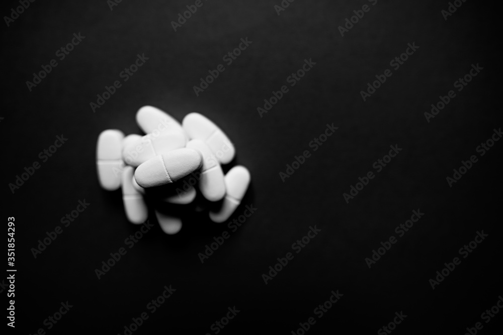 Wall mural White pills  on a paper background with a free area for text