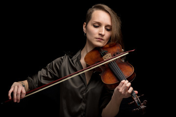 Professional female violinist playing in a concert