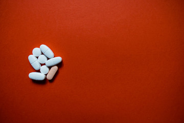 White pills  on a paper background with a free area for text