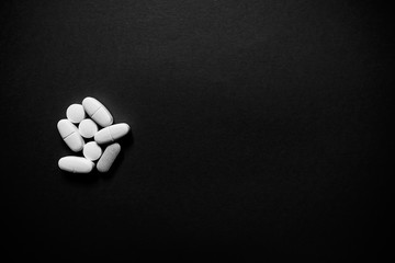 White pills  on a paper background with a free area for text