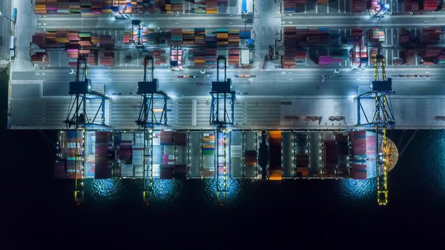 Time lapse Container , container ship in export and import business and logistics. Shipping cargo to harbor by crane. Water transport International. Aerial view and top view.