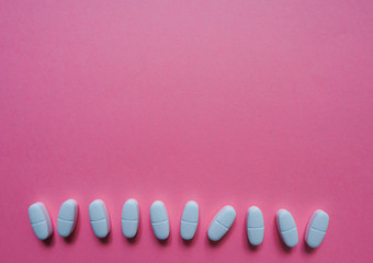 White pills  on a paper background with a free area for text