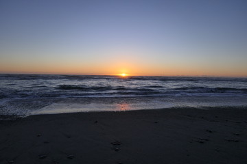 Fototapeta na wymiar Far advanced sunset on a beach in New Zealand 