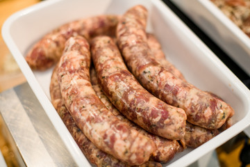 Close-up of raw meat sausage for cooking on grill