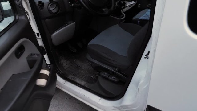 a gloved man opens a car door