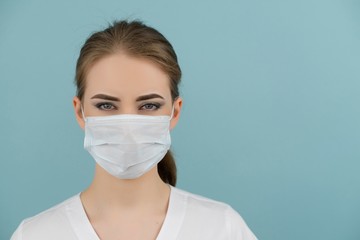 large doctor or nurse in a mask on a blue background