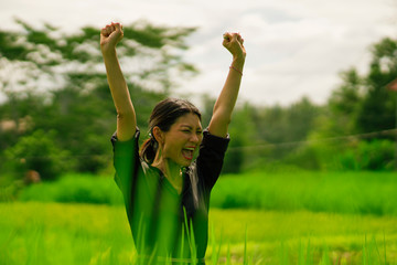 attractive and happy Asian Korean woman 40s or 50s enjoying nature excited and carefree playful at...