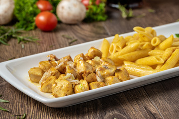 grilled cubed chicken with pasta and salad