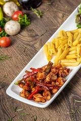 grilled cubed chicken with pasta and salad