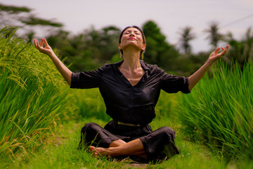 outdoors yoga and meditation at rice field - attractive and happy middle aged Asian Chinese woman...