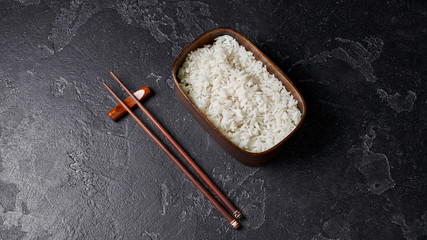 bento box with rice and chopsticks.