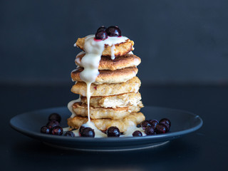 Oatmeal pancakes with berries and sweet sauce,