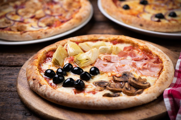 Pizza Four Seasons on wooden table