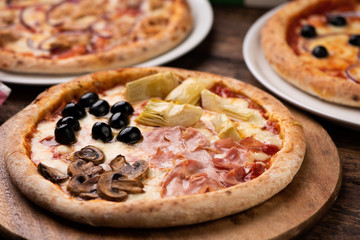 Pizza Four Seasons on wooden table