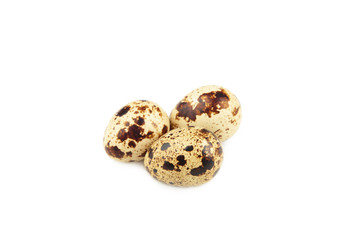 Three quail eggs isolated on white background
