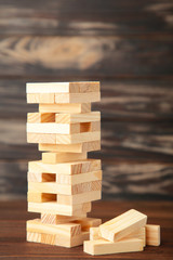 Blocks of wood on brown background. Tower